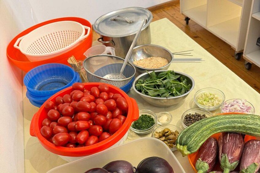 A table with various vegetables and cooking ingredients. 5