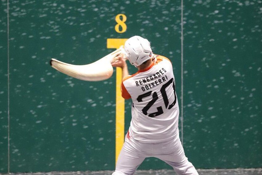 A cricket player in a white uniform with the number 25, holding a bat, and facing a green field with a yellow boundary line. 3