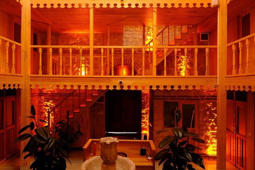 A wooden house with a balcony, a staircase, and a fireplace. 3