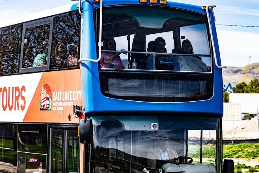 A blue double-decker bus with 'TOURS' and 'SALT LAKE CITY' written on the side. 2