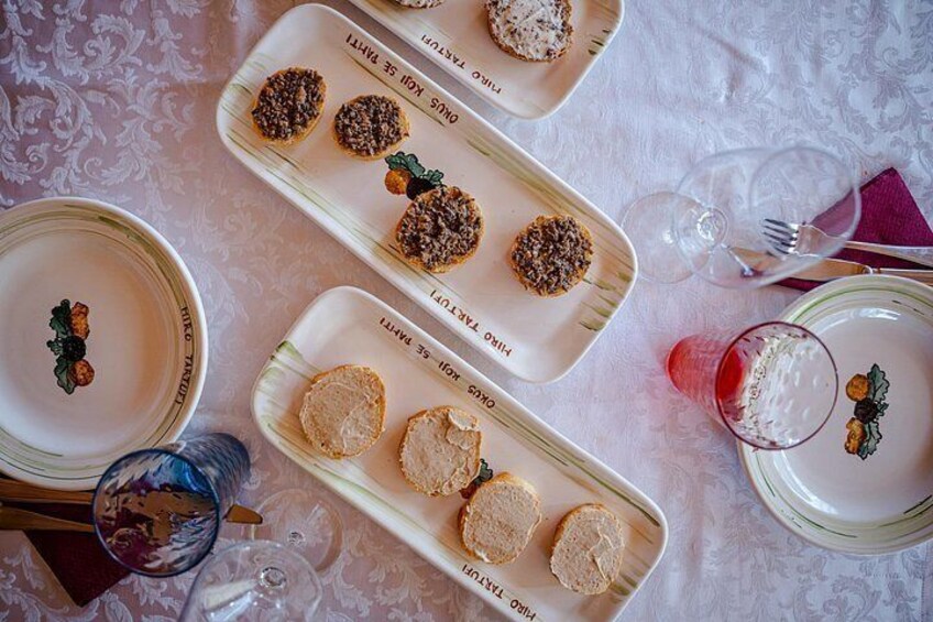 A table with plates of food, glasses, and cutlery. 3