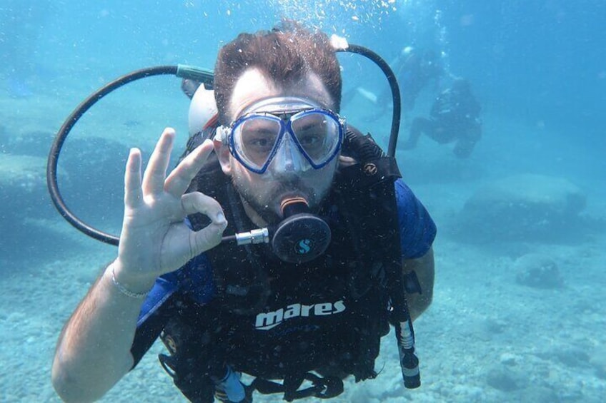 A scuba diver underwater with a 'mares' diving mask and regulator. 3