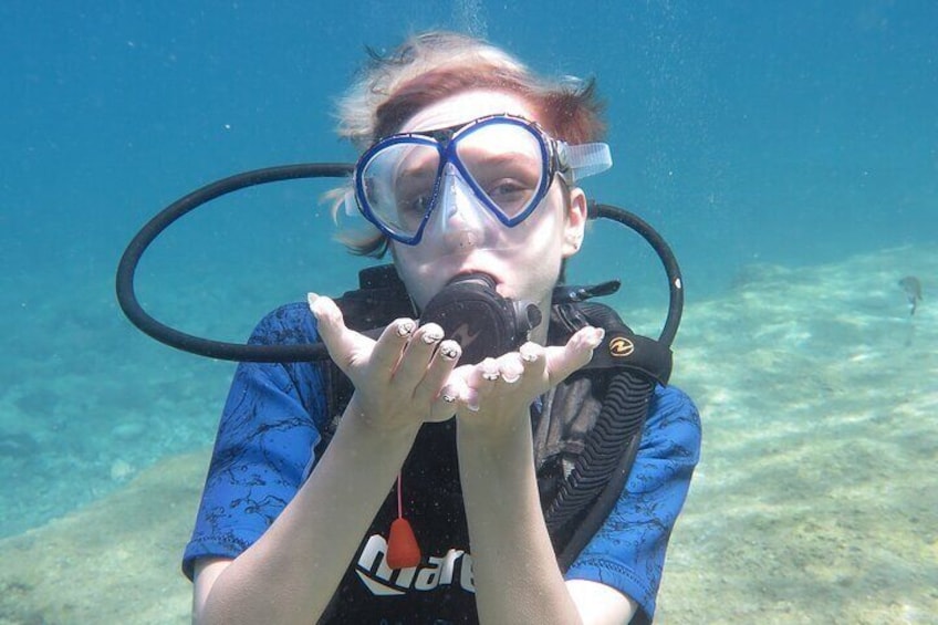 A person scuba diving underwater. 5