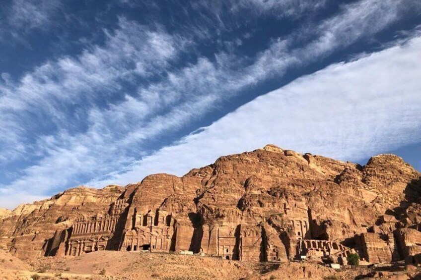 A desert landscape with ancient rock formations and ruins. 2