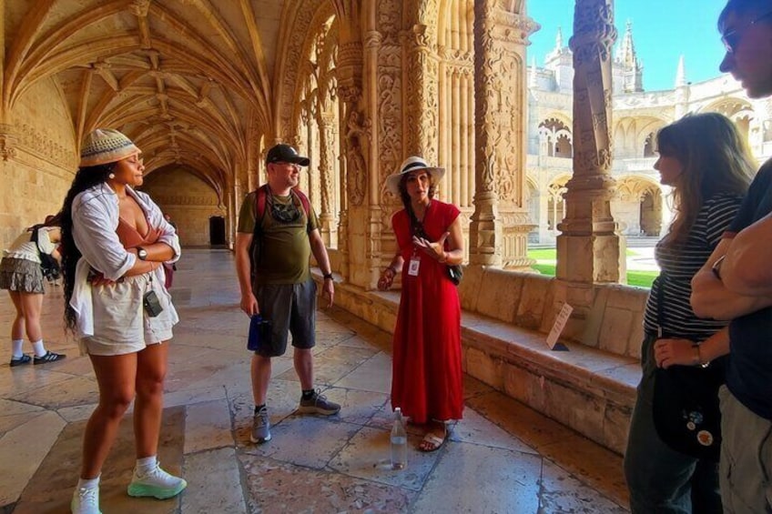 A group of tourists in a cathedral with Gothic architecture, including pointed arches and ribbed vaults. 1