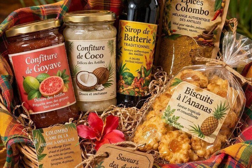 A variety of food items including a jar of confiture de goyave, a jar of confiture de coco, a bottle of sirop de batterie, and a package of biscuits à l'ananas. 3