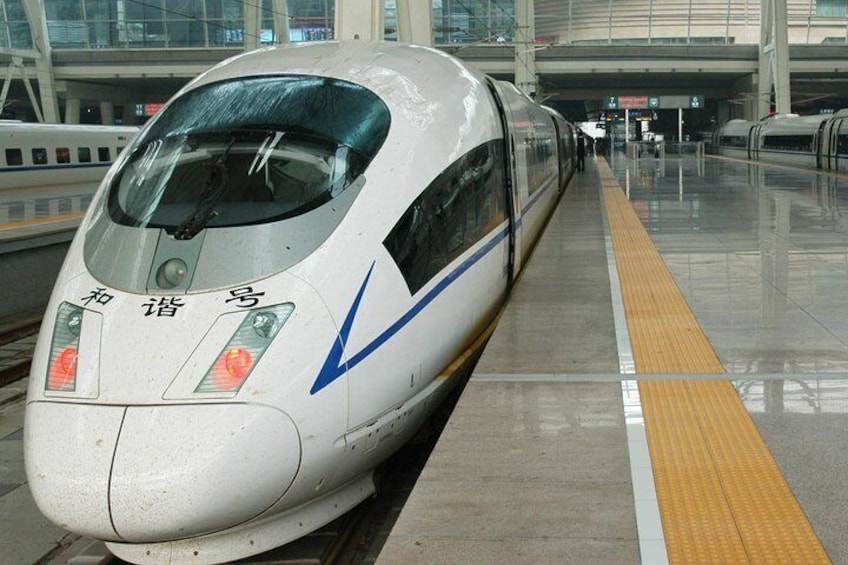 A high-speed train at a station platform. 4