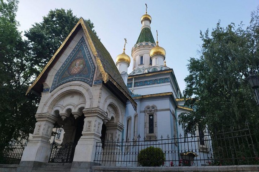 A church with a golden dome and a white facade. 5
