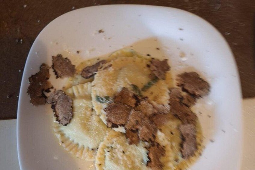 A white plate with remnants of food, possibly pasta, and some brown pieces that could be meat or vegetables. 5