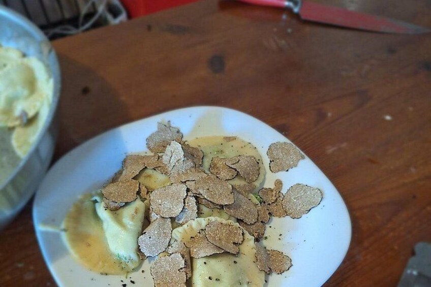A plate with a creamy dessert and crumbled cookies on a wooden table. 1