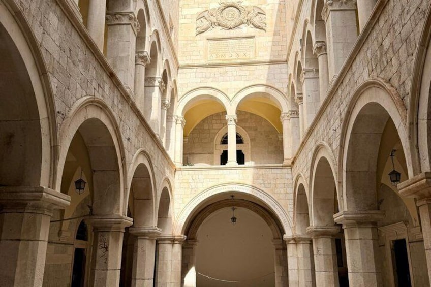 An interior courtyard with arches and a central open space. 3