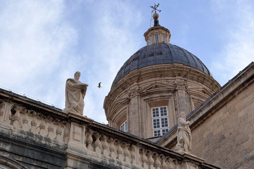A classical building with a dome and statues. 5