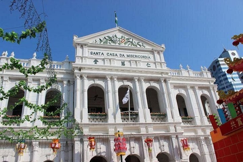 A white colonial-style building with arched windows and a sign reading 'Santa Casa da Misericordia.' 3