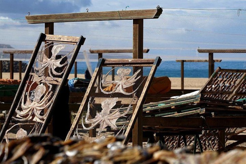 Beach chairs with intricate designs, a wooden structure, and the ocean in the background. 4