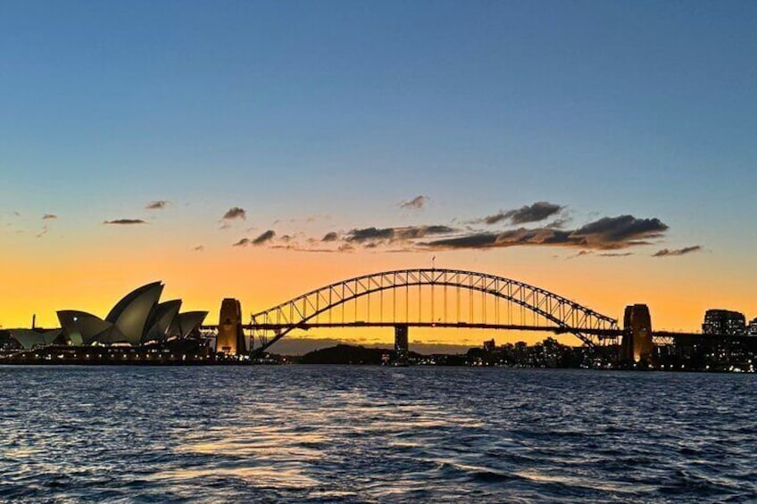 The Sydney Opera House and Sydney Harbour Bridge at sunset. 1