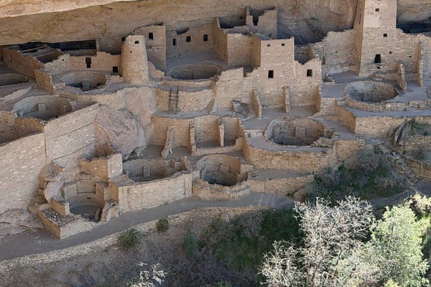 A large ancient cliffside settlement with multiple structures. 5