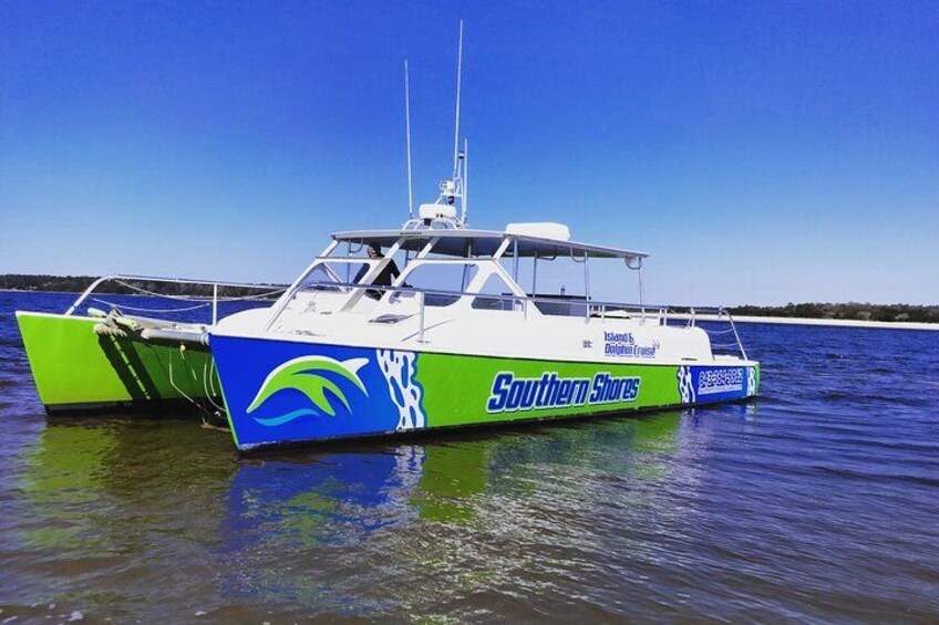A boat with 'Southern Shores' branding, docked in calm waters. 2