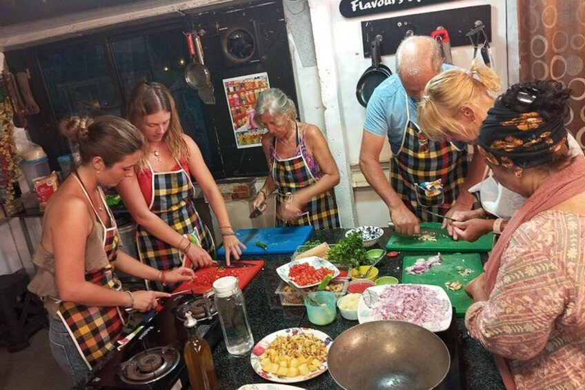 A group of people preparing food in a kitchen. 4
