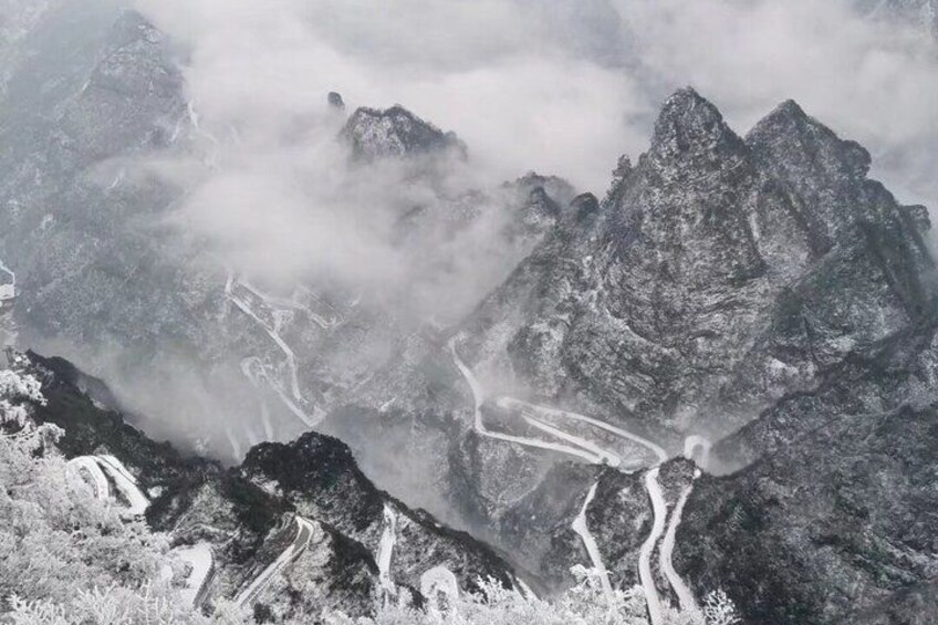 A mountainous landscape with snow-covered peaks and winding roads. 3