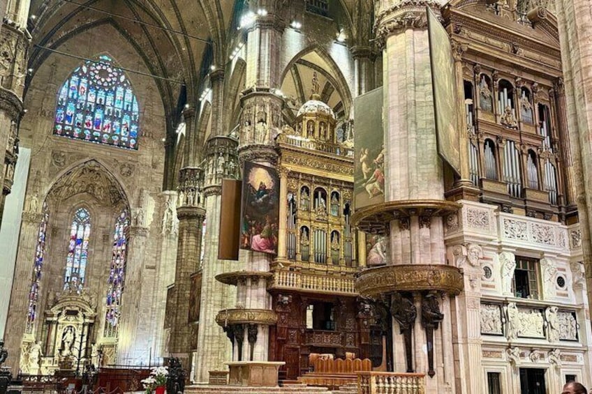 A grand cathedral interior with stained glass windows, ornate altars, and intricate stone carvings. 5