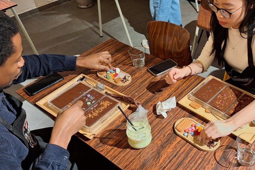 People sitting at a wooden table with desserts and drinks. 2