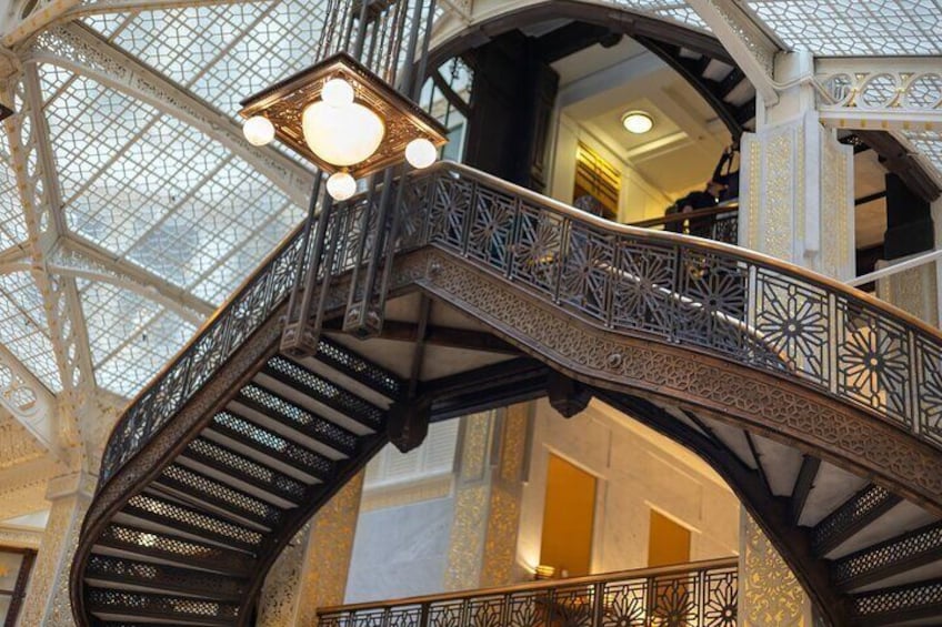 An ornate metal staircase with intricate designs, leading to a higher level. 5