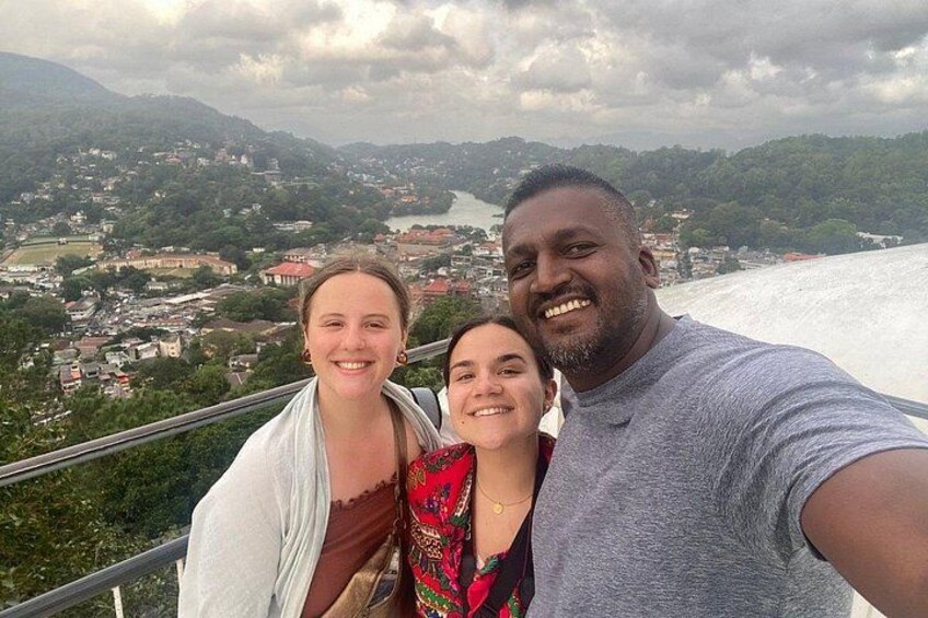 A scenic overlook with a river and mountains in the background. 4