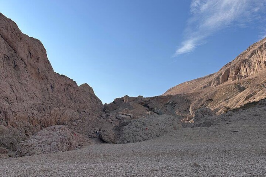 A desert landscape with rocky terrain and a clear sky. 1