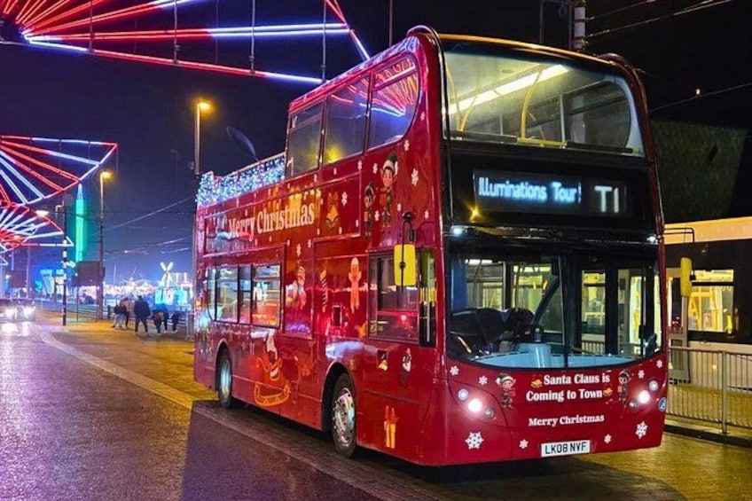 A red double-decker bus with 'Merry Christmas' decorations, labeled 'Illuminations Tour T1,' on a wet street at night. 1