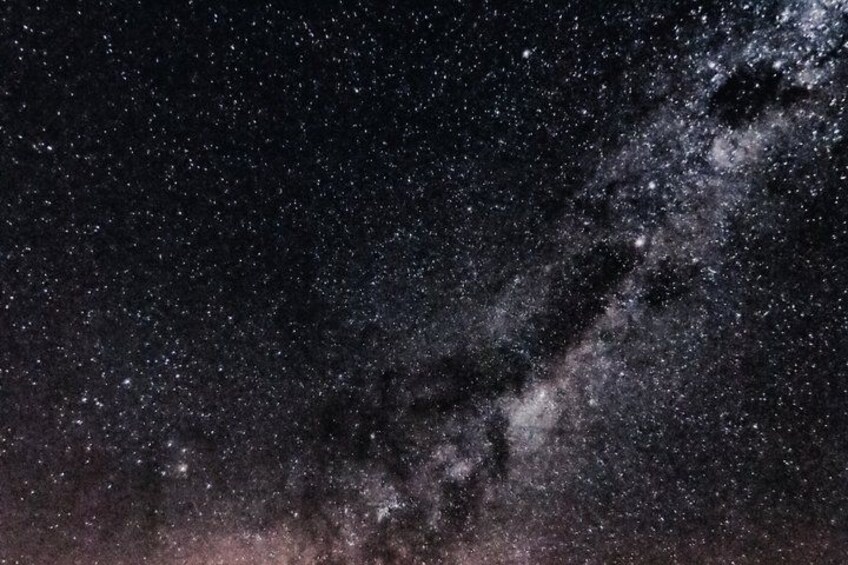 A starry night sky with a visible Milky Way galaxy. 4