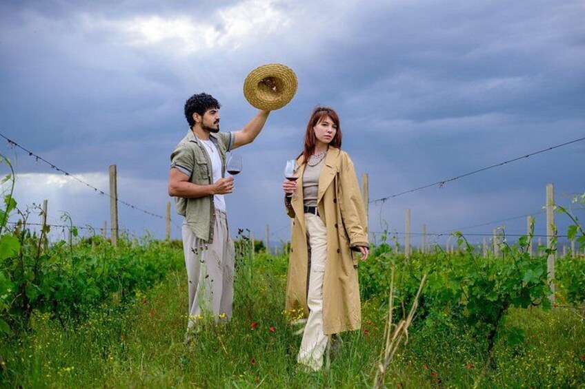 Two people in a field with a fence in the background. 1