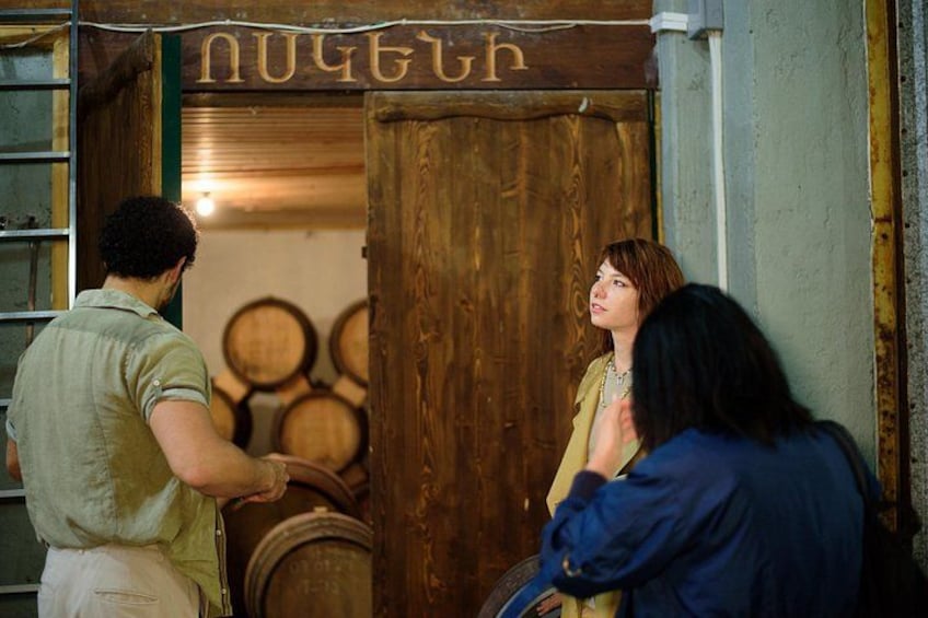 A wooden door with the word 'Nugget' carved on it, a person in a green shirt, and another person in a blue jacket. 3