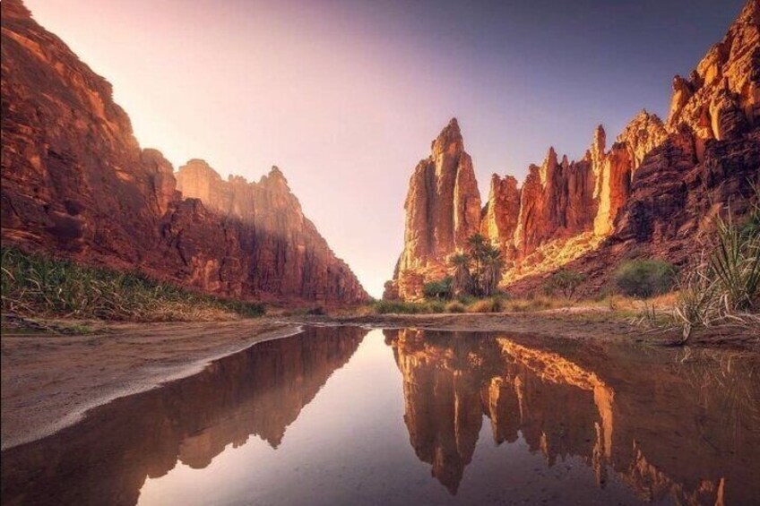 A river reflecting tall rock formations. 1
