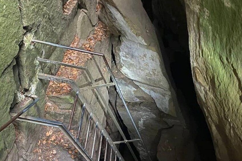 A metal staircase in a rocky cave. 5
