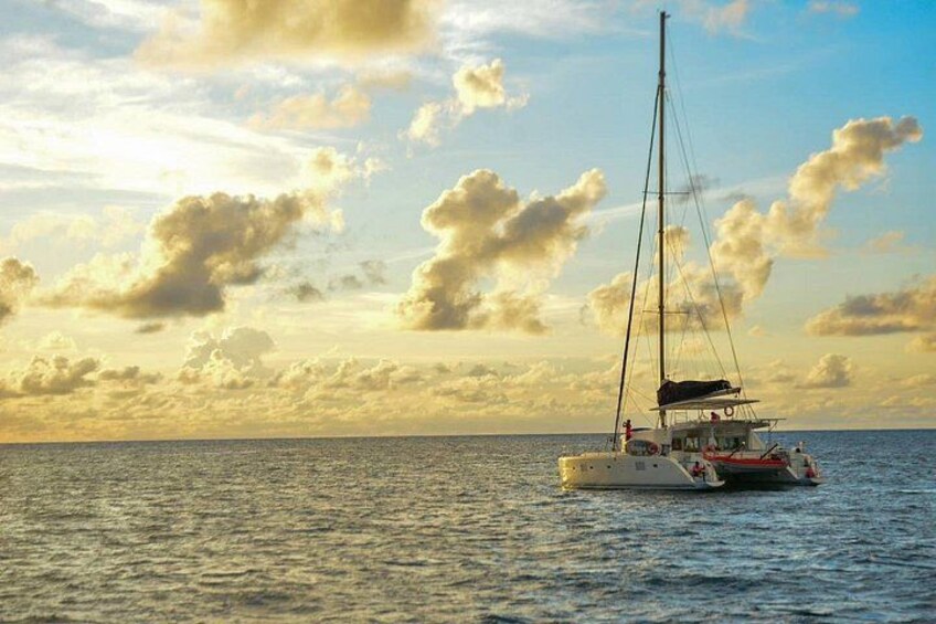 A sailboat on calm waters with a partly cloudy sky. 4
