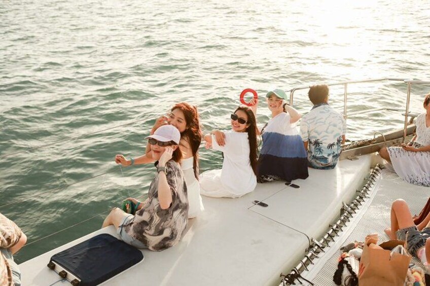 A group of people on a boat with water in the background. 5