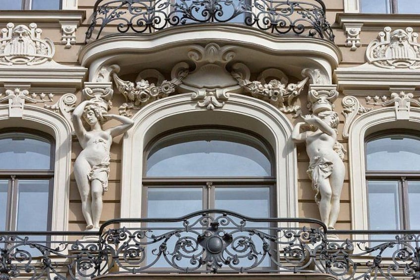 A building with ornate architectural details, including sculptures and decorative metalwork. 3