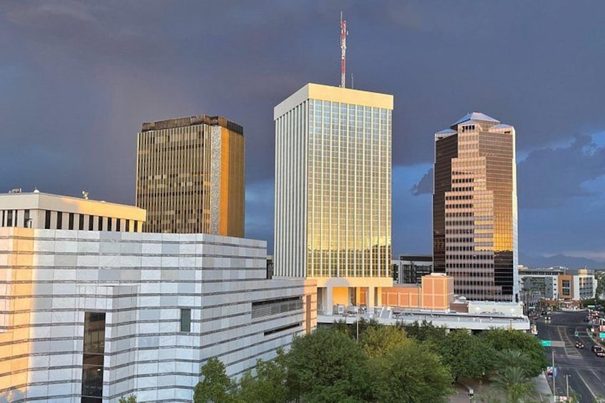 A cityscape with modern skyscrapers, a clear sky, and a river in the foreground. 5