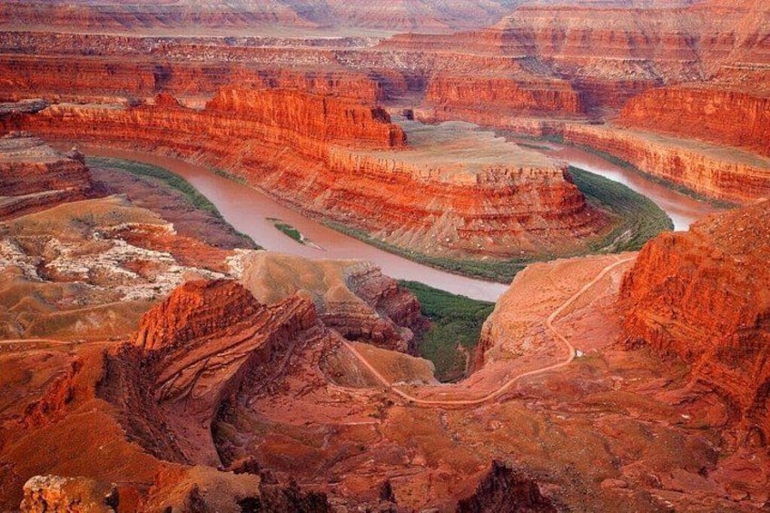 A canyon with layered rock formations and a river. 2