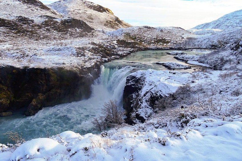 A snow-covered landscape with a waterfall. 3