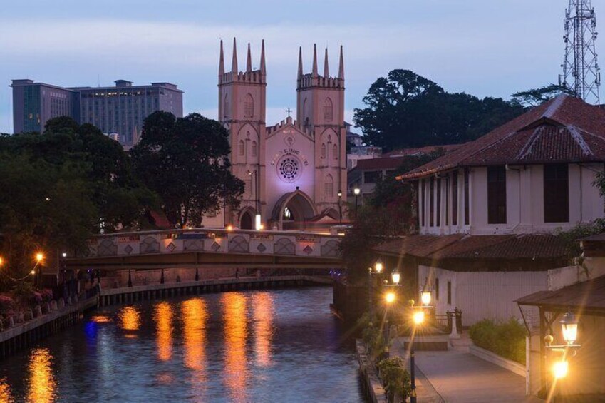 A bridge with a church in the background, a river, and street lamps. 5