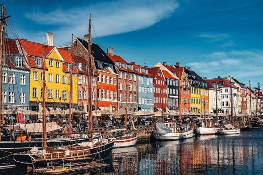 Colorful buildings along a waterfront with boats docked in the water. 5