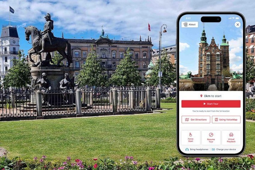 A statue of a man on horseback in a park with a historic building in the background. 1