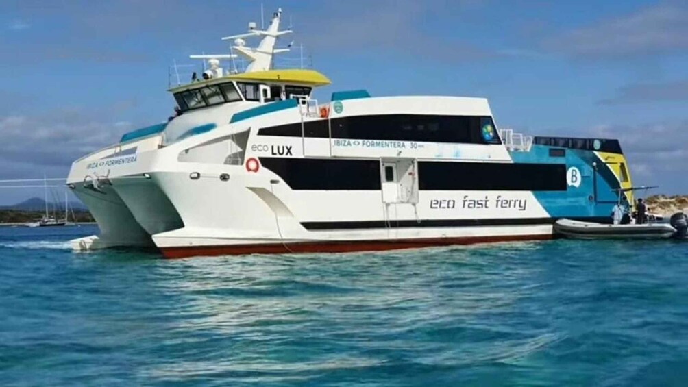 A white and blue ferry named 'eco fast ferry' with 'eco LUX' branding, docked at a port. 5