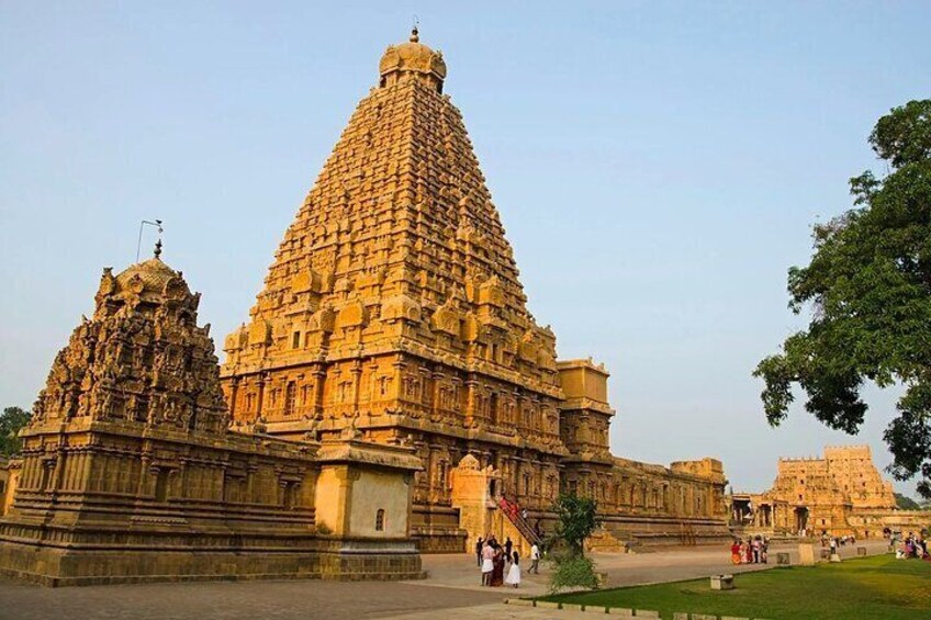 A large temple with a tall, pyramid-shaped tower and a smaller tower to the left. 1