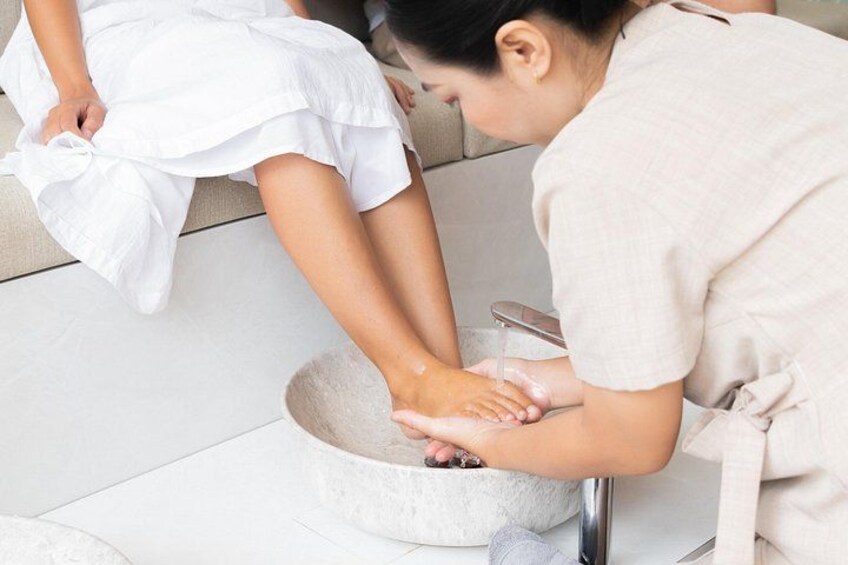 A person washing hands in a basin. 5