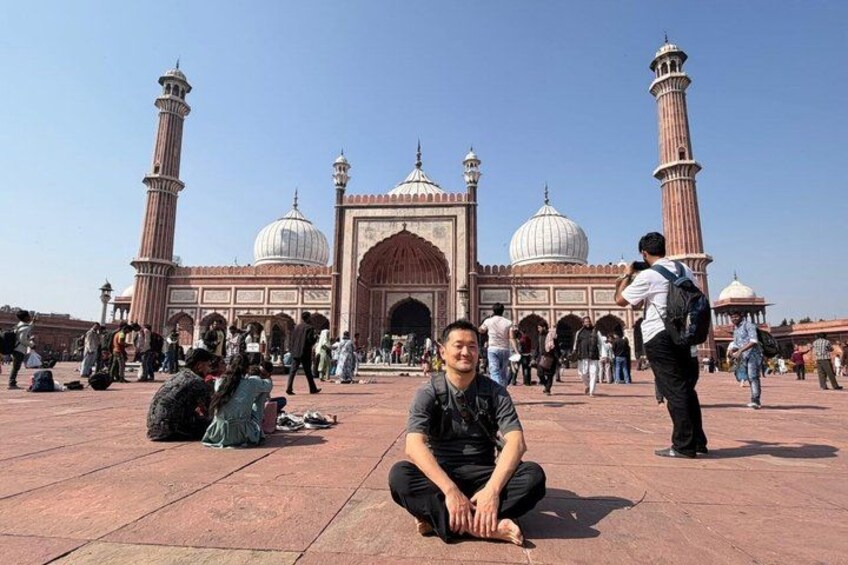 A historical building with domes and minarets, surrounded by people. 4