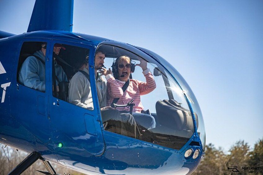 A blue helicopter with passengers inside. 3