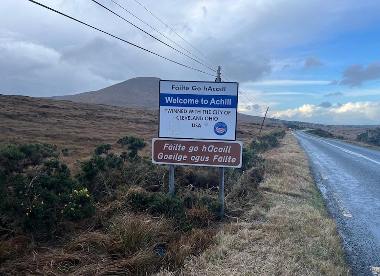 A welcome sign to Achill, twin town with Cleveland, Ohio, USA, and a bilingual sign in English and Irish. 3