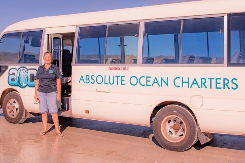 A white bus with "ABSOLUTE OCEAN CHARTERS" written on the side. 3